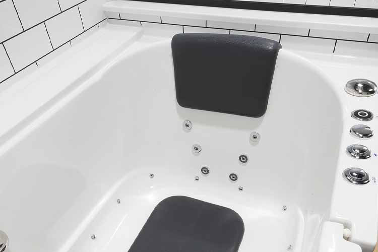 white bathtub with jets