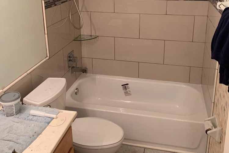 white bathtub with tiles